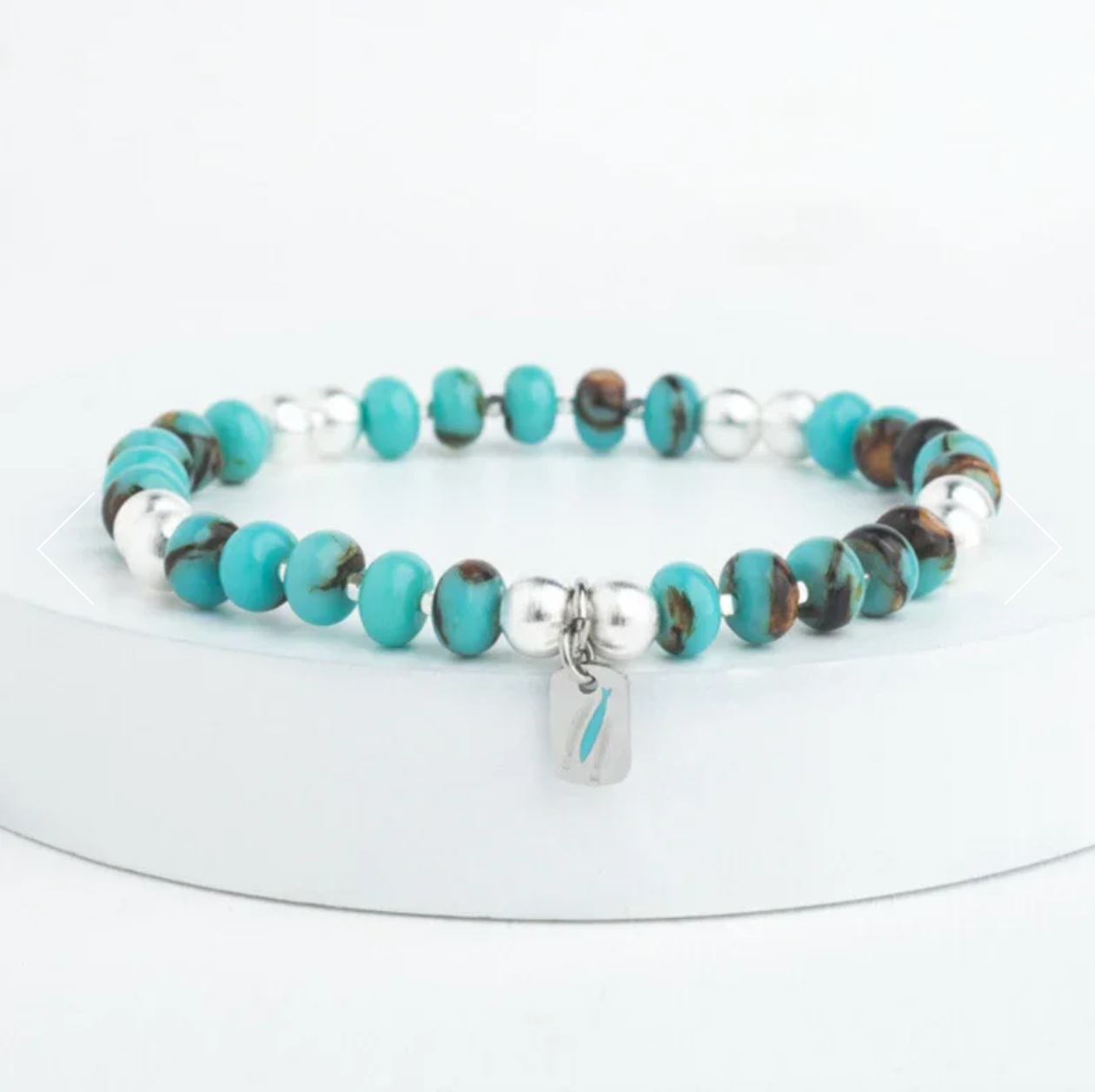 Beaded bracelet with turquoise, brown, and silver beads on a white background